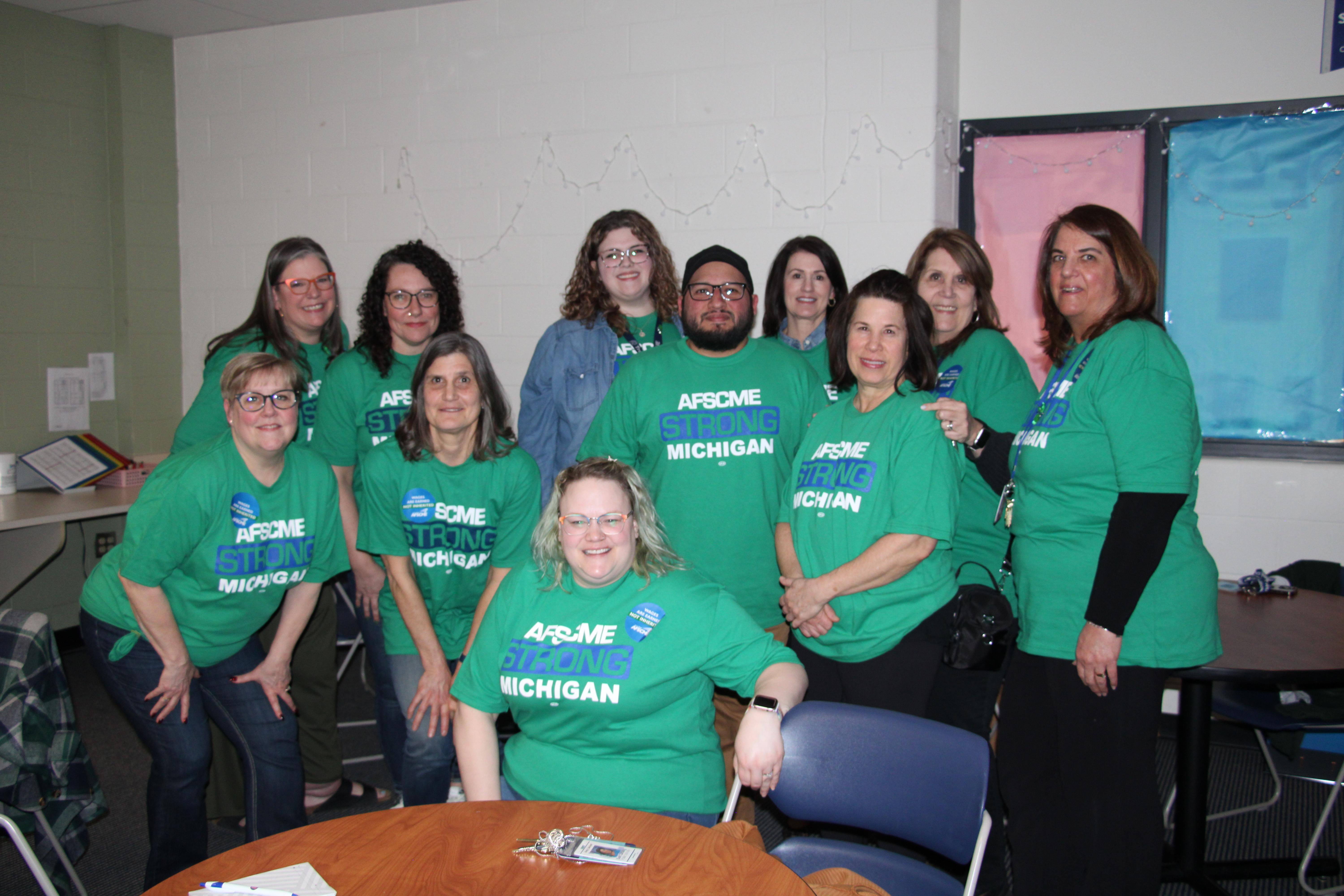 East Lansing Schools Administrative Assistants wear green and speak out in solidarity at District Board Meeting.