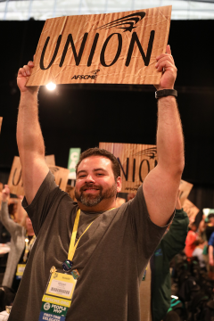 Union member holding union sign
